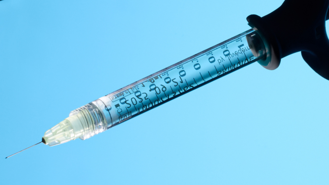 Syringe with a blue background